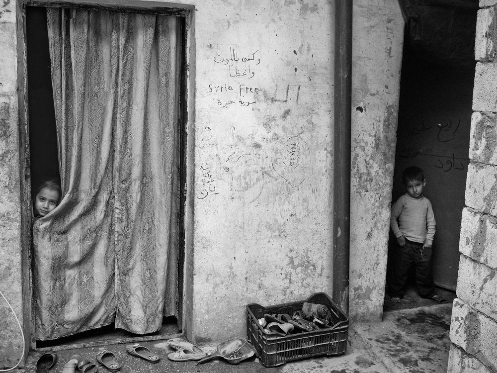 Syrian refugees living on the grounds of a former prison now occupied by several Syrian refugee families on the outskirts of the village of Majdal Anjar, in Lebanon's Bekaa Valley.