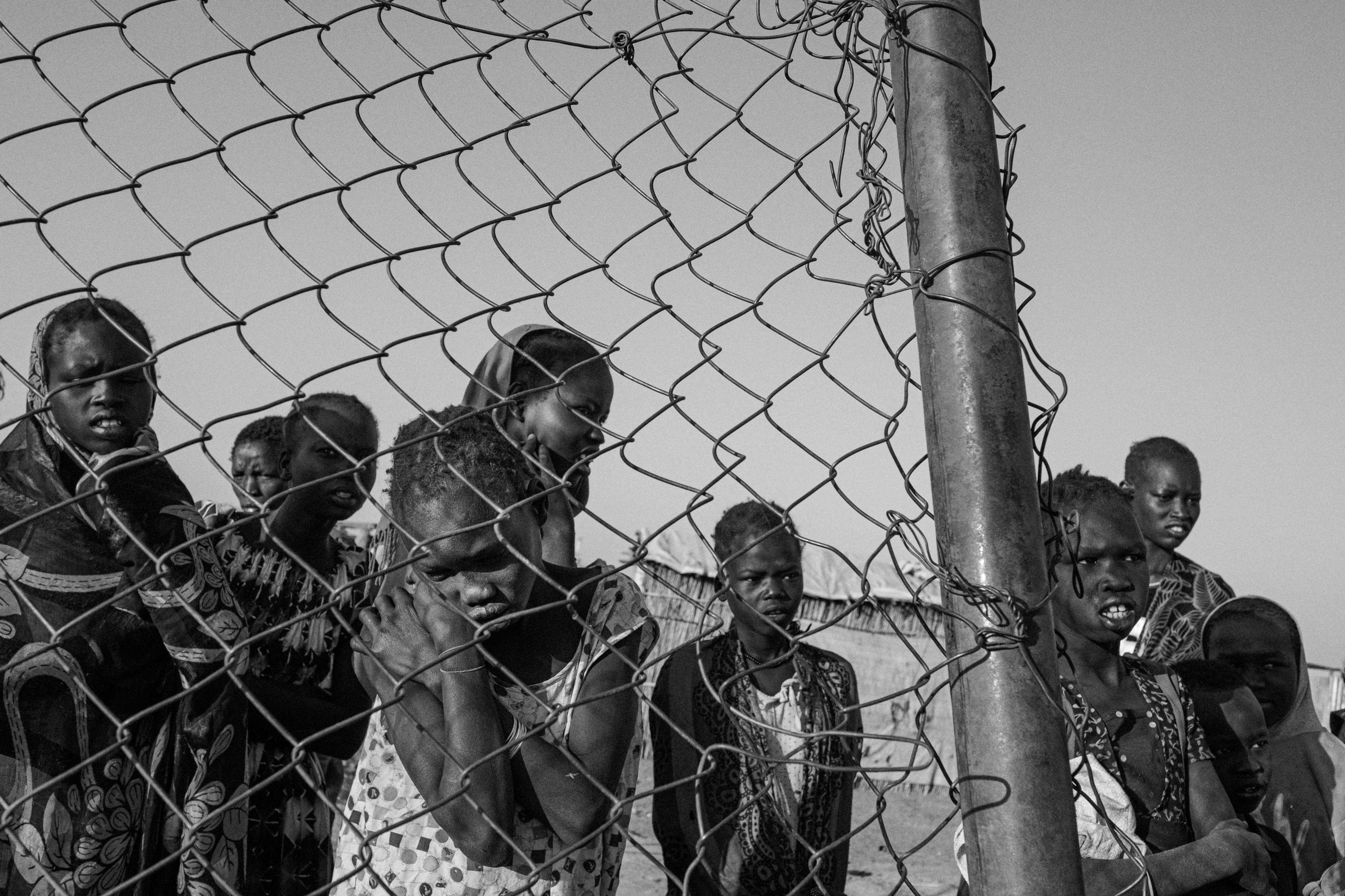 Girls behind a fence.