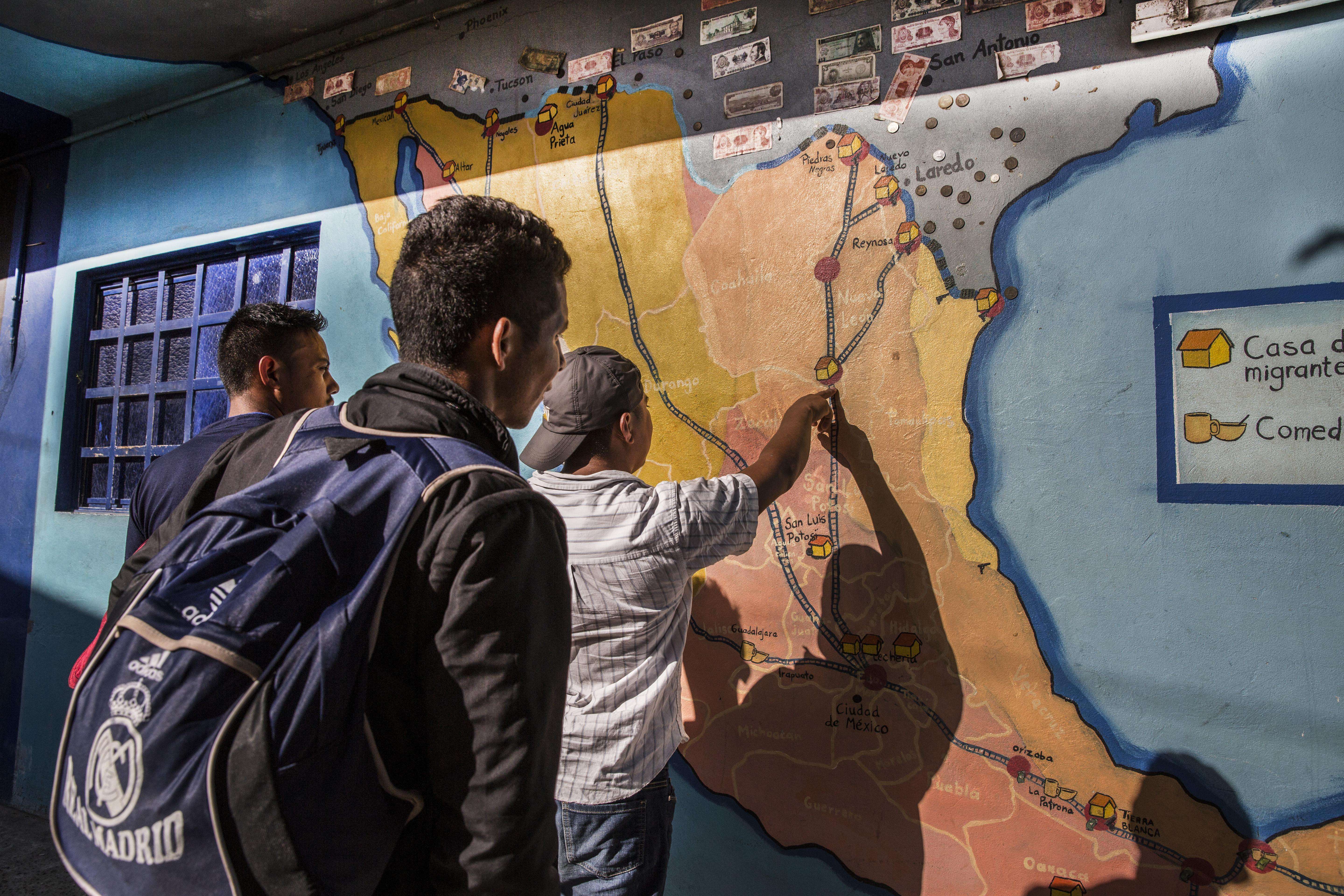 Men check a map at the La 72 migrant shelter in Tenosique, Mexico.