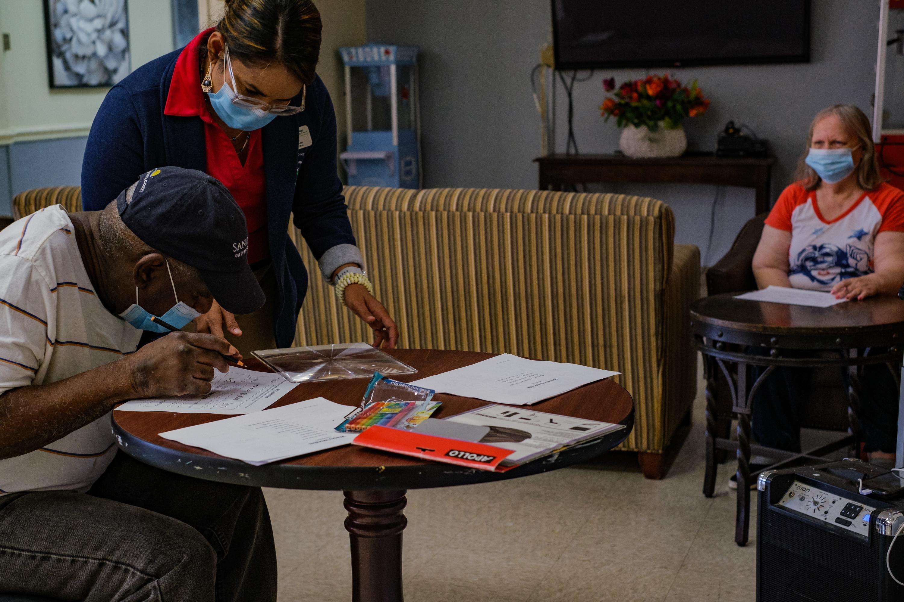 Nursing home staff working with residents on a project 