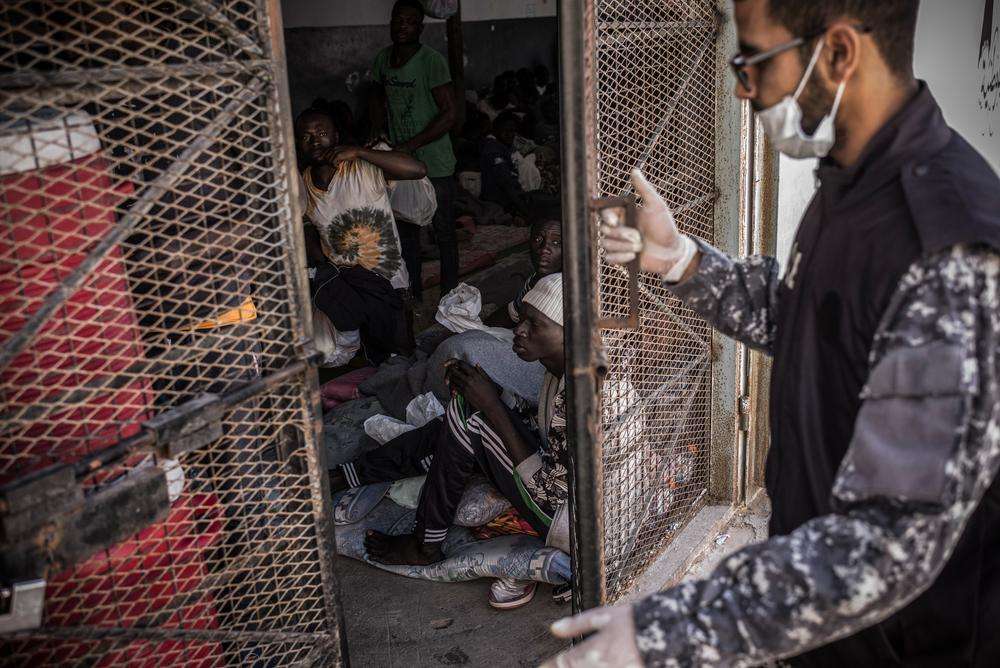 A guard is closing the door of a cell in Abu Salim detention center, in Tripoli, Libya.