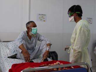 A medic speaks with a patient