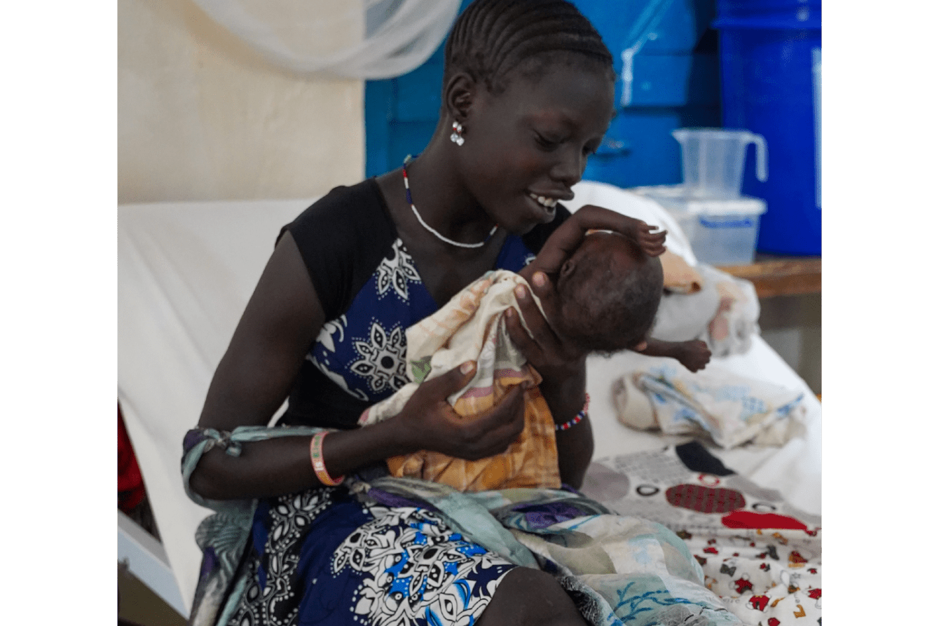 A woman cradles her newborn baby in South Sudan.