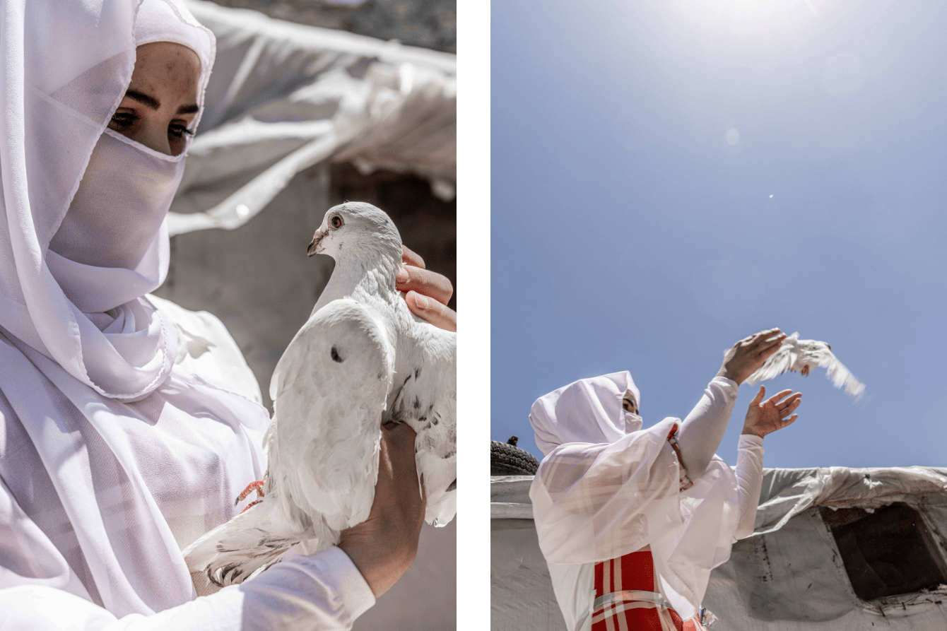 A girl in white hijab releases a dove into the sun in Lebanon.