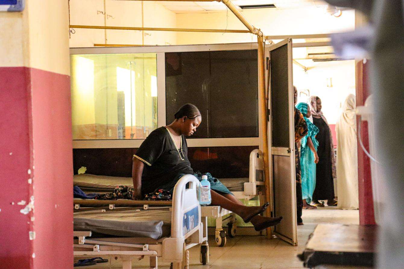 A woman sits on a hospital bed in South Darfur, Sudan.