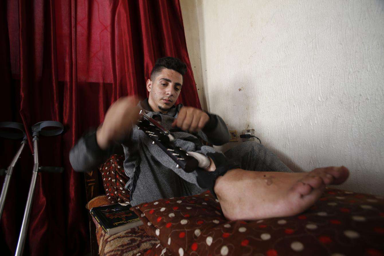 Iyad, 23, in his house in Gaza.